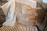 Textured cactus silk pillow featuring varied geometric patterns in light blue, yellow, and orange.