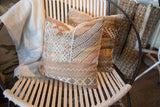 Cactus silk pillow, intricate woven geometric patterns in subtle beige and pastel tones.