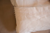 Close-up of the organic cotton canvas backing with envelope closure stitching.