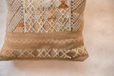 Handwoven cactus silk pillow detail with natural toned geometric and wavy patterns.