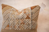 Textured cactus silk pillow featuring intricate geometric patterns in earthy tones.