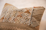 Sabra silk pillow close-up featuring raised geometric diamond pattern in varying earth tones.