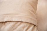 Natural organic cotton canvas pillow backing with white envelope closure stitching.