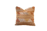 Brown cactus silk pillow with horizontal bands of orange, gold, and white geometric patterns.