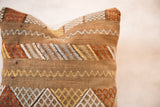 Cactus silk pillow detail with brown, white, blue, and orange geometric patterns.