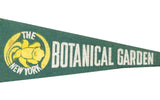 Green felt New York Botanical Garden banner with white text and yellow flower graphic.
