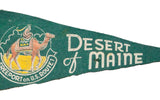 Vintage green felt 'Desert of Maine' banner, camel graphic and visible wear.