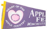Purple felt banner detail: pink heart apple graphic and 