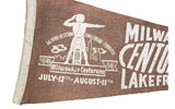 Angled view of brown felt Centurama banner, white graphics, saluting figure, and aged white trim.
