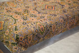 Angled detail of the purple Bibikabad Persian rug fragment, featuring peach and olive green floral motifs.