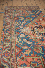 Antique Serapi runner's worn edge with ornate floral border and vibrant geometric field.