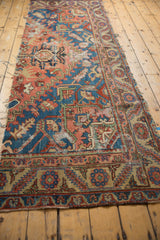 Serapi rug fragment border detail, showing aged sapphire blue, dusty blush, and beige geometric motifs.