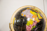 Detailed view of the Mid Century Cram's black globe, showing Africa's colorful nations.