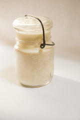 Vintage Ball canning jar featuring dark wire bail and clear glass lid.