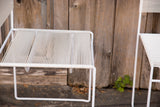 White spaghetti cord seat and frame of a vintage Flyline chair.