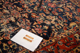 Close-up of the distressed, finely woven pile on a vintage Bibikabad rug with floral details.