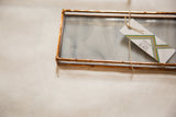 The Debbie Bean brand tag attached to a small stained glass tray with a copper frame.