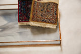 Copper-edged stained glass tray displaying swirled opaque and clear waterglass.