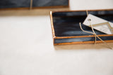 Small black stained glass tray with copper patina edges and marbled deep blue-black glass.