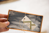 Debbie Bean Stained Glass tag, copper patina frame, and marbled dark glass.