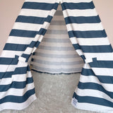 Teepee interior view with navy and white striped fabric and fluffy white rug.