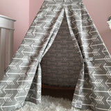 Gray kids teepee entrance with white arrow pattern, held open by fabric ties.