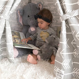 Kids gray teepee interior, showing child reading, plush elephants, and arrow pattern.
