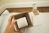 Walnut veneer lampshade frame showing interior craftsmanship and white plaster base.