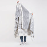 Handmade Modern Blanket in gray and white with patchwork geometric patterns.