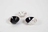 Three unique handmade modern ring dishes, black and ecru speckled glaze, tiny legs.