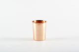 Bright, pure copper cup featuring a smooth, reflective surface and rolled rim.