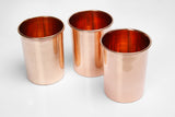 Lower edge of three hand-made copper cups, highlighting natural material variations.