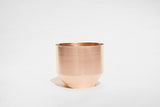 Modern copper planter with a subtle brushed finish and tapered base.