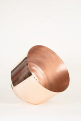 Shiny pure copper planter's top rim and perforated self-watering reservoir detail.