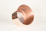 Modern copper planter's interior with perforated aluminum self-watering reservoir.