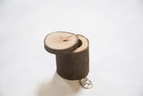 Salvaged log wooden ring box, open, with magnet visible and two rings.