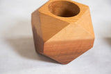 Close-up of natural cedar wood planter, with distinct grain and geometric facets.