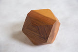 Natural wood grain detail on a faceted side of the geometric cedar planter.