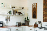 Angular layered reclaimed wood art with ombre charred and whitewashed tones.