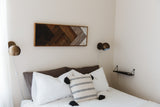 Modern wood art with angular reclaimed wood, ombre panels, dark to white.