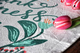 Textured Mom Tea Towel with teal script, orange floral detail, and pink tulip.