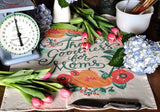 Partial view of the Mom Tea Towel's 'Thank Goodness for Moms' script, red and orange florals.
