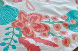 Natural unbleached cotton tea towel detail, with coral pink flower and teal leaf print.