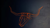 Orange geometric wire sculpture of a longhorn head with prominent horns.