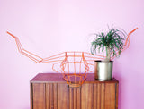 Bold orange wire Longhorn sculpture featuring geometric lines and wide horns.