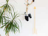 Gold powder-coated modern arrow wall art with geometric fletching.