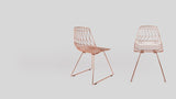 Pair of modern Lucy side chairs with geometric copper wire mesh.