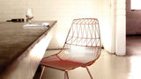 Geometric wire pattern on the copper backrest of the Modern Lucy Side Chair.