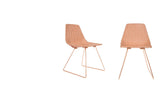 Lucy side chair's copper wire legs and textured camel leather seat pad.