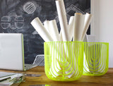 Two sculptural lime green wire baskets, one holding rolled white papers.